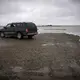 Robert's car parked along coastal shore. Image by Nick Mott. United States, 2019.