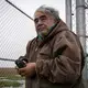 Robert Thompson, Kaktovik polar bear guide, holding his binoculars. Image by Nick Mott. United States, 2019.