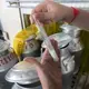 Workers test each can of milk dropped off for bacteria and quality at the Pakchong Dairy Cooperative. Image by Mark Hoffman. Thailand, 2019. 