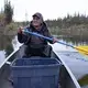 Gideon James rowing out on the creek that runs through Arctic Village. Image by Amy Martin. United States, 2019.