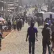 People move about the main thoroughfare in the Kawangware slum. Image by Mark Hoffman. Kenya, 2017. 
