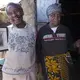 Paul Mugai Ngage (left) and his wife, Ann Wanjiku, proudly display photos of their ancestors at their home in the Kawangware slum. The couple and their extended family live with some of their children and grandchildren in a house with a corrugated metal roof and a yard filled with livestock, including sheep, goats, rabbits, ducks, dogs and chickens. Image by Mark Hoffman. Kenya, 2017. 