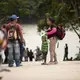 Migrants stop near a restaurant in La Técnica. They had recently exited a bus that arrived from the interior of the country and planned to cross into Mexico before heading north toward the United States. Image by Miguel Gutierrez Jr. Guatemala, 2019.