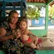 Maria de Lourdes da Fonseca Lima trims the fingernails of her granddaughter, Riquelme da Silva Lima, 3, at their home in the Virola Jatoba settlement in Anapu. Image by Spenser Heaps. Brazil, 2019.