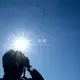 A man captures shots of JASDF planes. Image by Emiko Jozuka. Japan, 2018. 