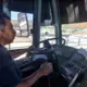Margarito Cruz Gallarno steers his bus past the San Ysidro Port of Entry. Image by Patrick Reilly. Mexico, 2017.<br />
