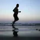 In this Feb. 13, 2018, photo, a man jogs on the beach after the sun sets in Aden, Yemen. Image by Nariman El-Mofty. Yemen, 2018.</p>
<p>
