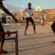 Young men play soccer in the recently completed public plaza in Canaan 1, a neighborhood of greater Canaan. Since the city’s inception as a haven for people who were displaced by Haiti’s 2010 earthquake, its residents have been largely left to themselves. Image by Allison Shelley. Haiti, 2019.