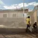 Boys rest along the foundation of an inaugurated but not yet staffed police post in the Canaan 1 neighborhood. Currently there are just 14 police officers stationed in Canaan, serving the city’s 280,000 to 320,000 residents. Image by Allison Shelley. Haiti, 2019.