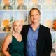 Executive Producer Don Thompson and filmmaker Erin McGoff stand for a photo in front of posters for 'This Little Land of Mines.' Image by Matt Francisco. United States, 2019.