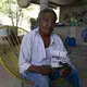 Wilfrido Martinez holds a photo of his 39-year-old son Mauricio, who died from COVID-19 in New York, as he poses for a portrait at his home in San Jeronimo Xayacatlan, Mexico, Friday, June 26, 2020. Martinez said his son, who worked in a restaurant kitchen in New York, was diabetic and didn't protect himself against infection. Until his son died, he himself had believed the virus was a fraud perpetrated by politicians for reasons he did not understand. Image by Fernando Llano/AP Photo. Mexico, 2020.
