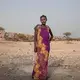 In this July 15, 2019 photo, 15-year old Medres, a migrant from Ethiopia, poses for a portrait, as she and others take shelter on the last stop of their journey before leaving by boat to Yemen in the evening, in Obock, Djibouti. She said she doesn't speak Arabic_ the majority language in the oil-rich Kingdom. She was told that she should be able to learn the language in one month. She could earn as much as 2500 to 3000 riyals, about 700 U.S. dollars. Image by Nariman El-Mofty / AP Photo. Djibouti, 2019.