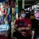 Abdul and Hanifa are selling cloth masks in the public market. Before the pandemic, they sold cellphones, which are now not considered essential goods. They started selling masks to continue to have an income during the lockdown. Image by Xyza Bacani. Philippines, 2020.