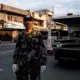 Police officer Emmanuel Ventura works a quarantine checkpoint. Image by Xyza Bacani. Philippines, 2020.